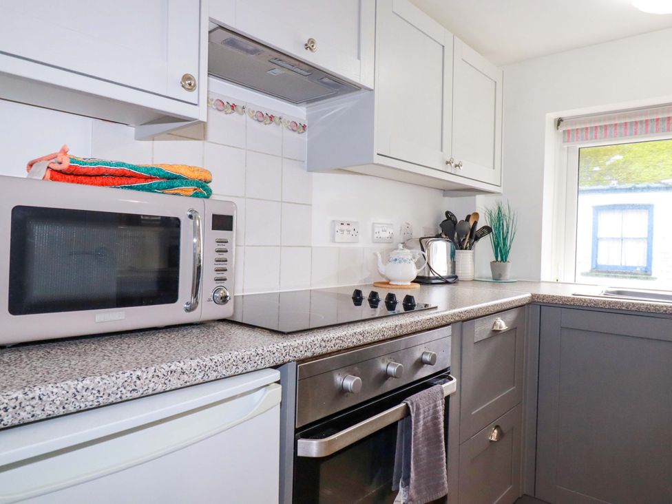 A kitchen with various appliances and utensils at The Penthouse in Looe