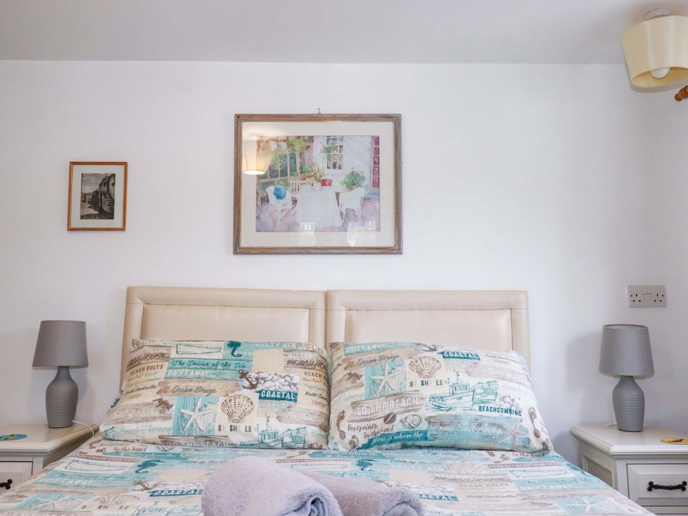 A bedroom with a bed and bedside table at The Penthouse in Looe