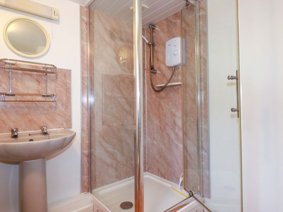 A bathroom with a sink and shower at The Penthouse in Looe
