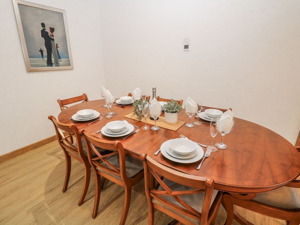 A dining room with a table set for dinner at Courtyard View in Ashbourne