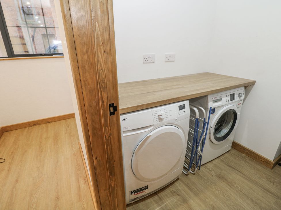 A laundry room with washing machine and tumble dryer at Courtyard View in Ashbourne