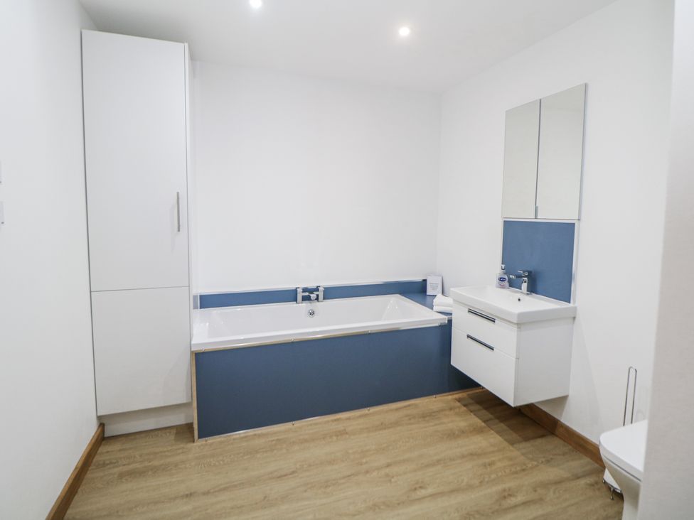A bathroom with a bathtub, sink, and toilet at Courtyard View Ashbourne