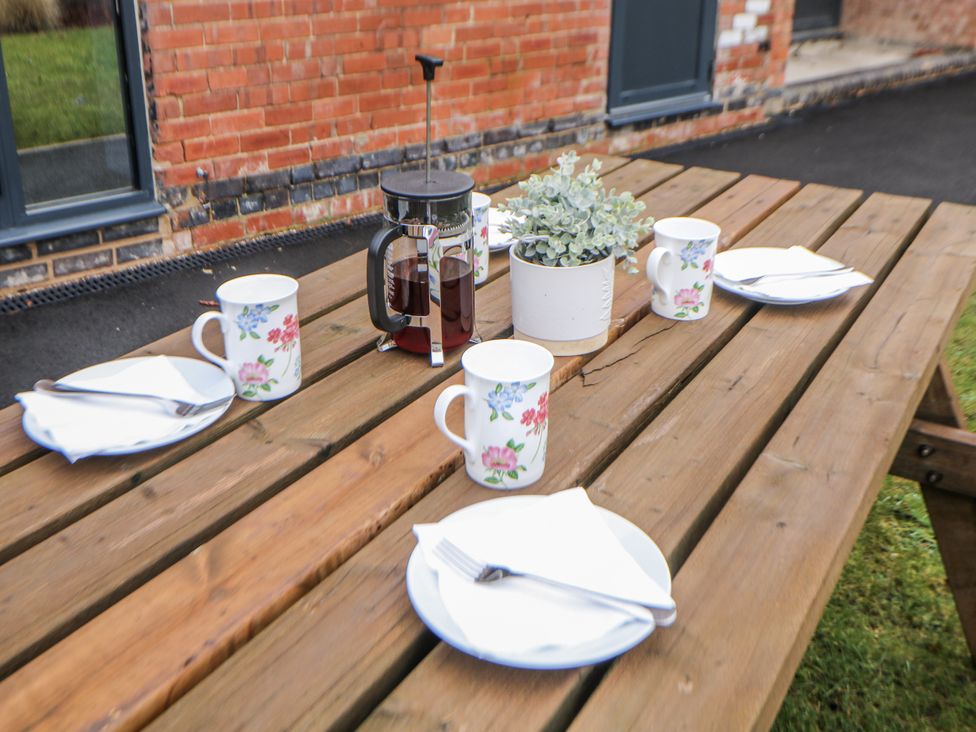 An outdoor dining area with a table set for coffee at Courtyard View in Ashbourne