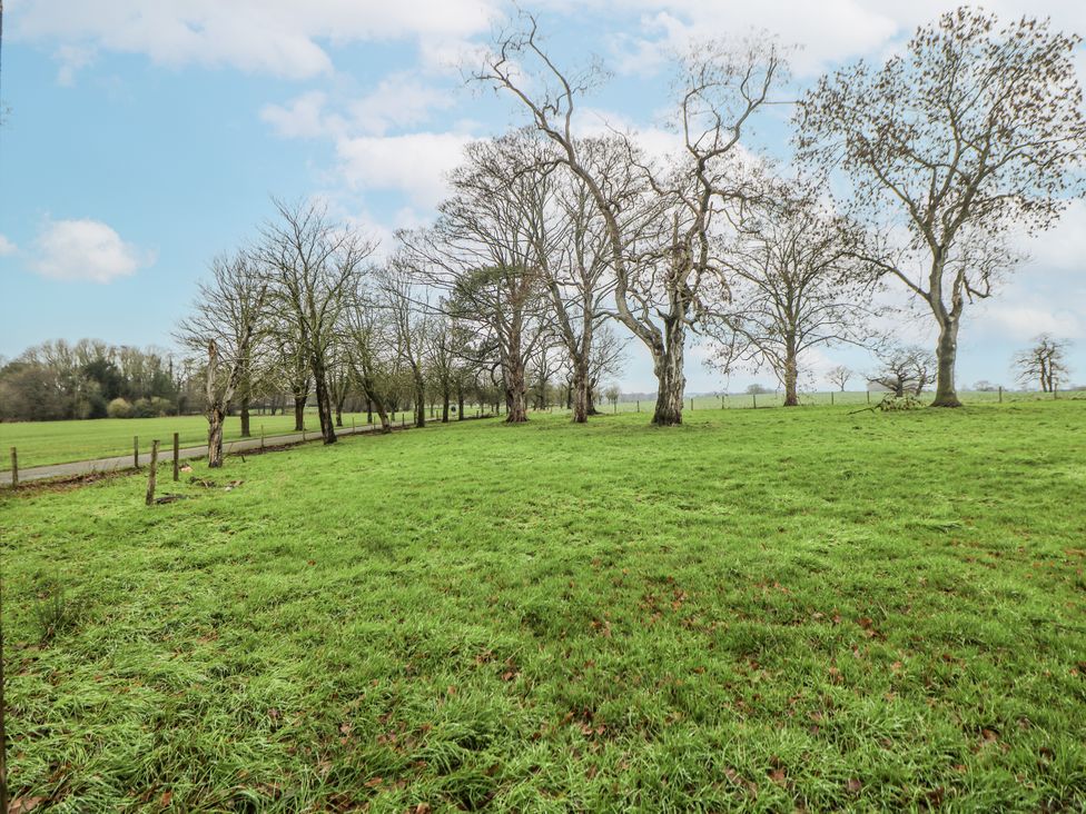 A field with trees and a fence at Courtyard View Ashbourne