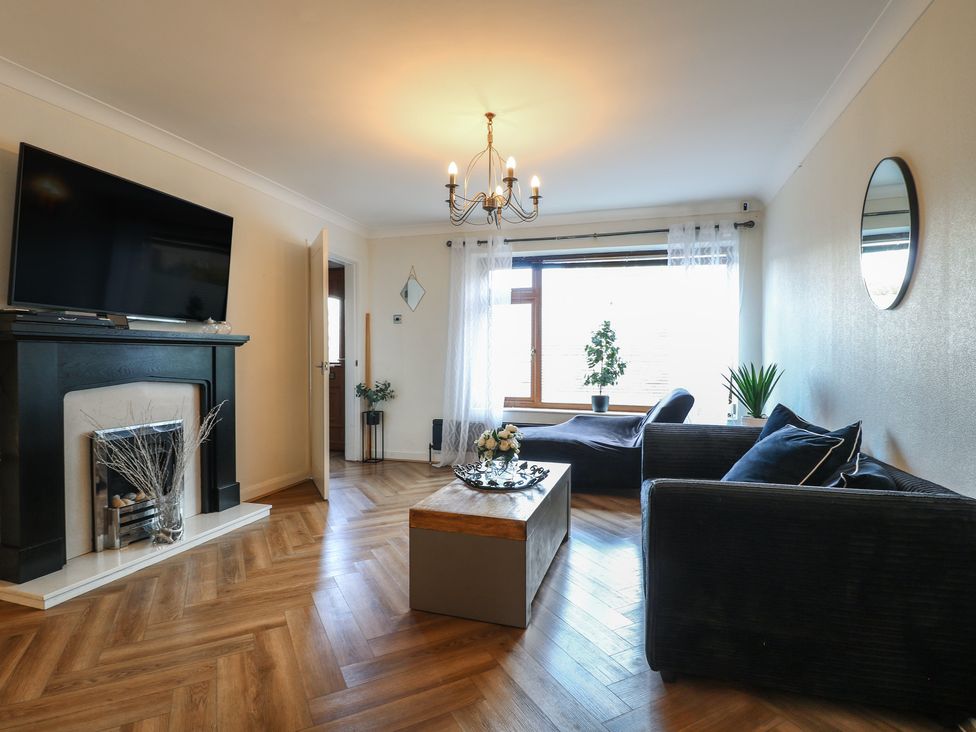 A living room with a television, fireplace, and coffee table at 57 Howden Avenue Doncaster