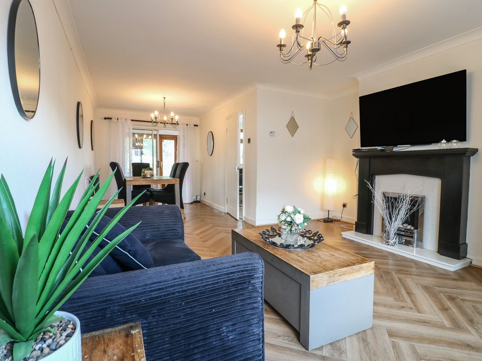 A living room with a sofa, coffee table, and television at 57 Howden Avenue, Doncaster