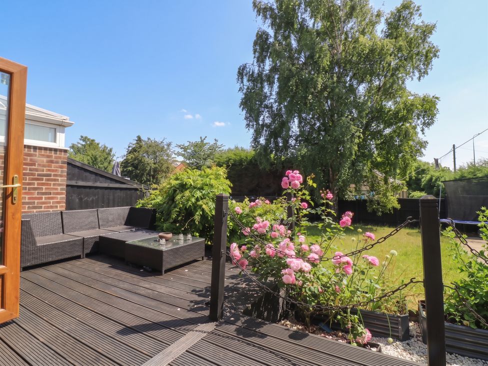 A garden with seating area and flowers at 57 Howden Avenue Doncaster