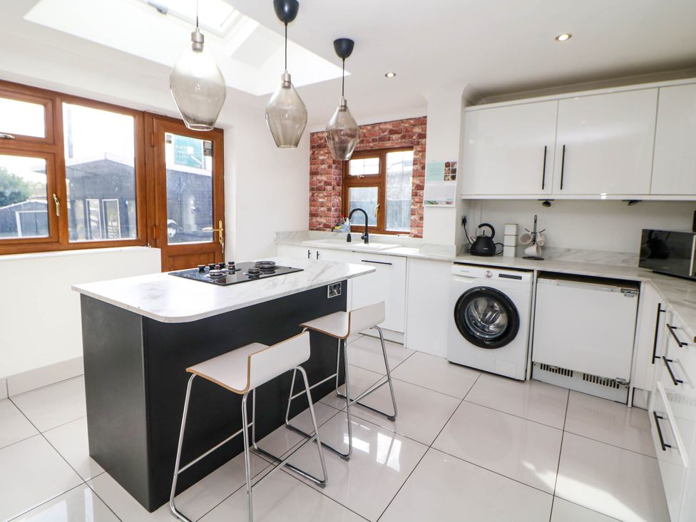 A kitchen with an island and appliances at 57 Howden Avenue Skellow
