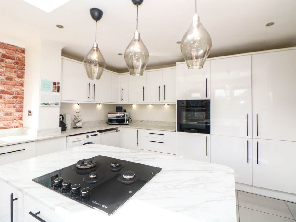 A kitchen with a countertop and cooktop at 57 Howden Avenue in Skellow