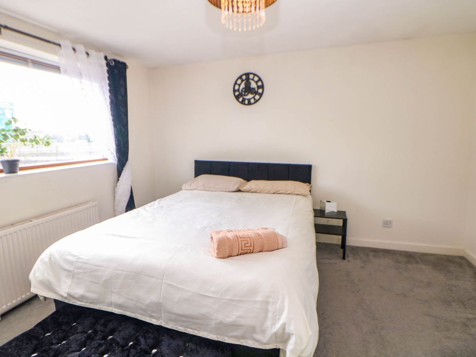 A bedroom with a bed and nightstand at 57 Howden Avenue Skellow