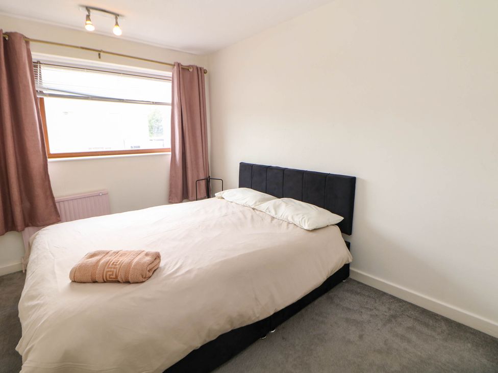 A bedroom with a bed and curtains at 57 Howden Avenue Skellow