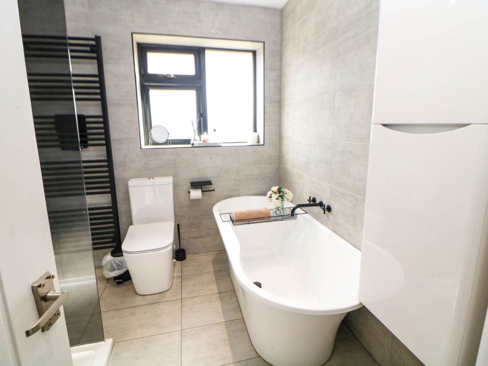 A bathroom with a bathtub and sink at 57 Howden Avenue Skellow