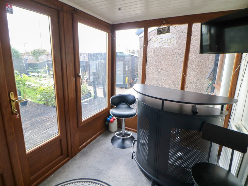 A conservatory with bar seating area at 57 Howden Avenue Skellow
