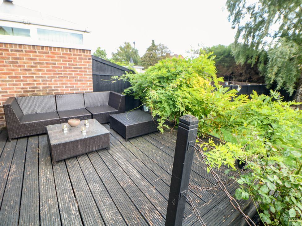 An outdoor seating area with a sofa and coffee table at 57 Howden Avenue Skellow