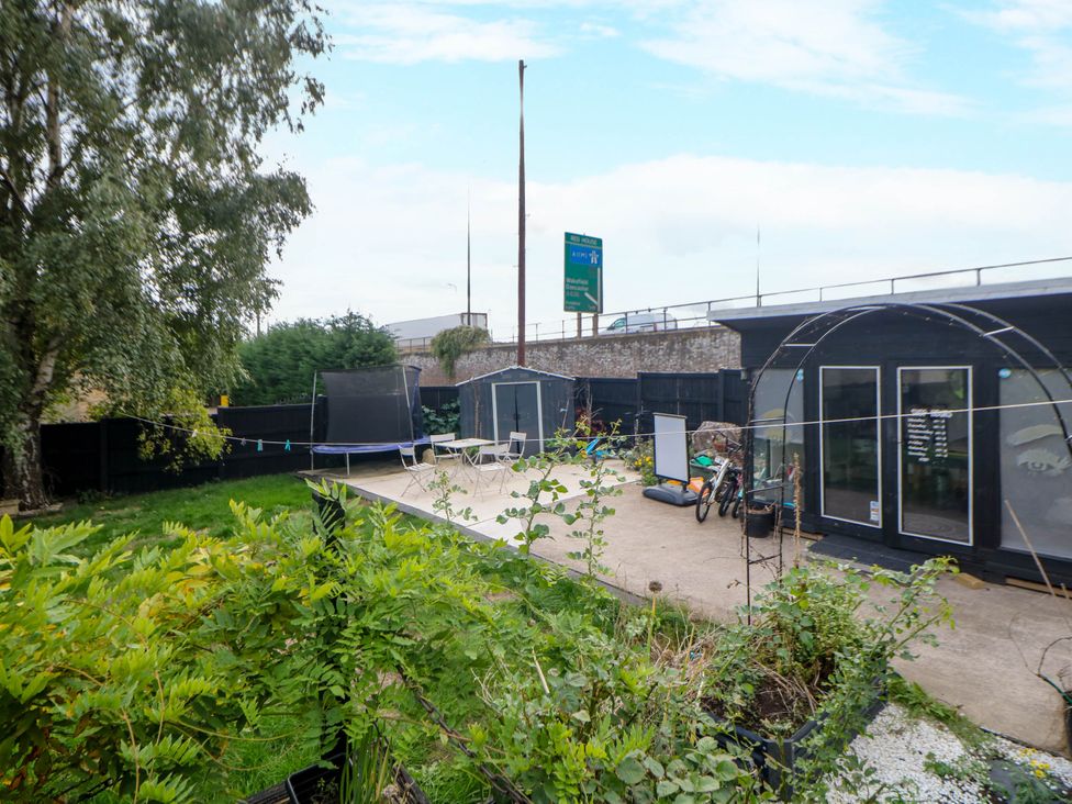 A garden with a trampoline and chairs at 57 Howden Avenue in Skellow