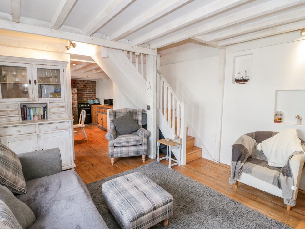 A living room with a sofa and armchair in Studio Bach Beaumaris