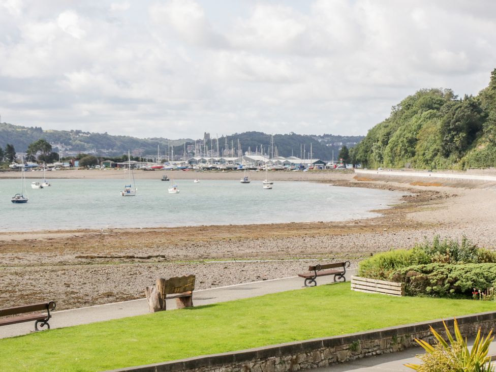 A view of boats on water by a rocky shore at Studio Bach in Beaumaris