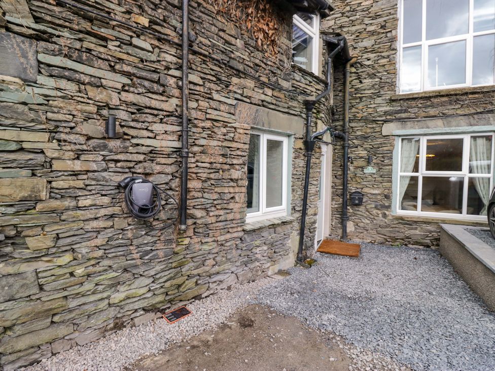 An outdoor area with stone walls and a door at Flat 5 Caxton House in Windermere