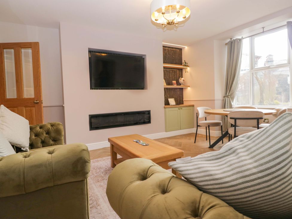 A living room with a sofa and coffee table at Flat 5 Caxton House in Windermere