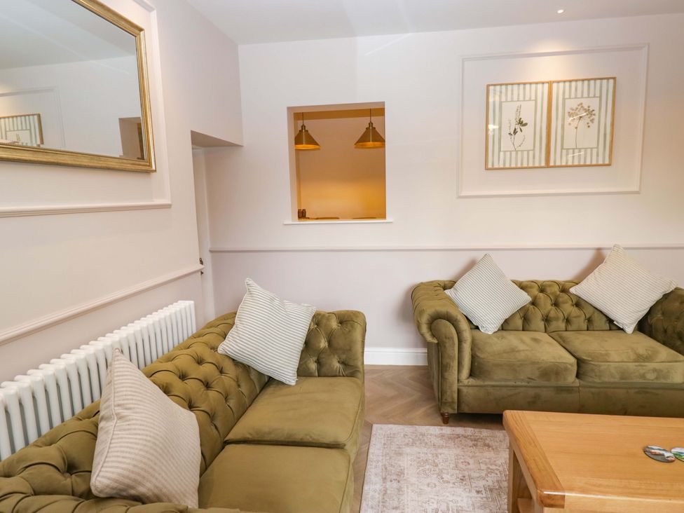 A living room with sofas and a coffee table at Flat 5 Caxton House in Windermere
