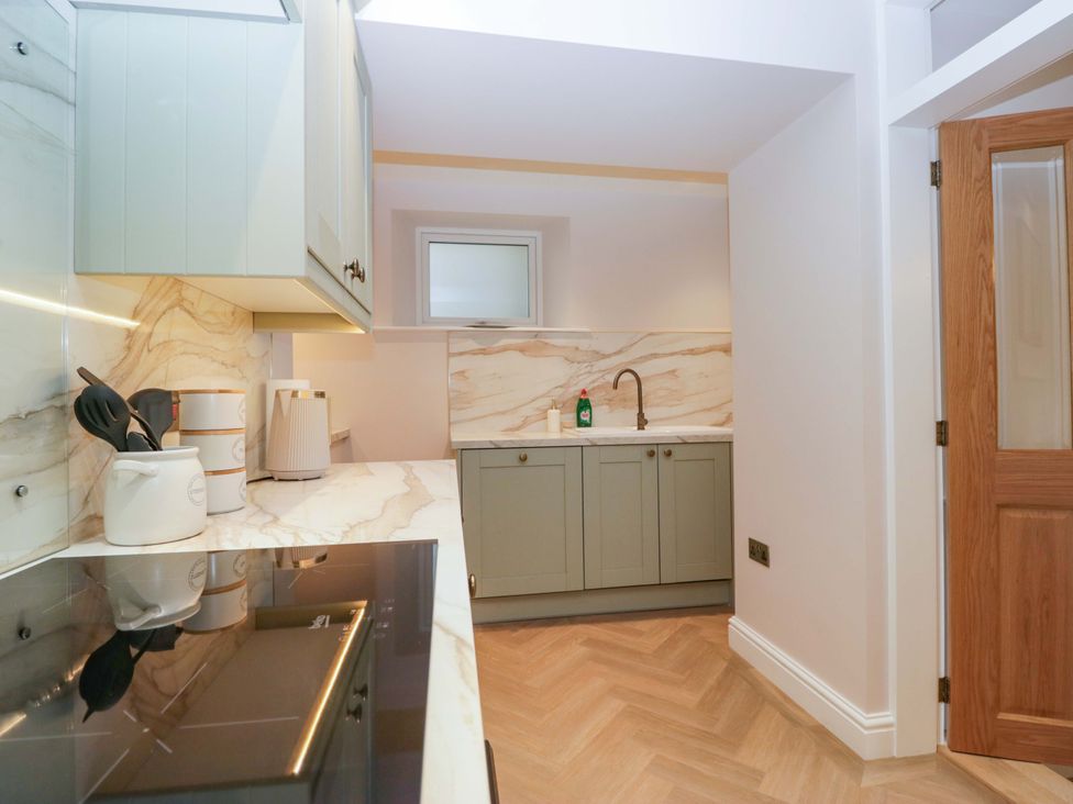 A kitchen featuring cabinets and a sink at Flat 5 Caxton House Windermere
