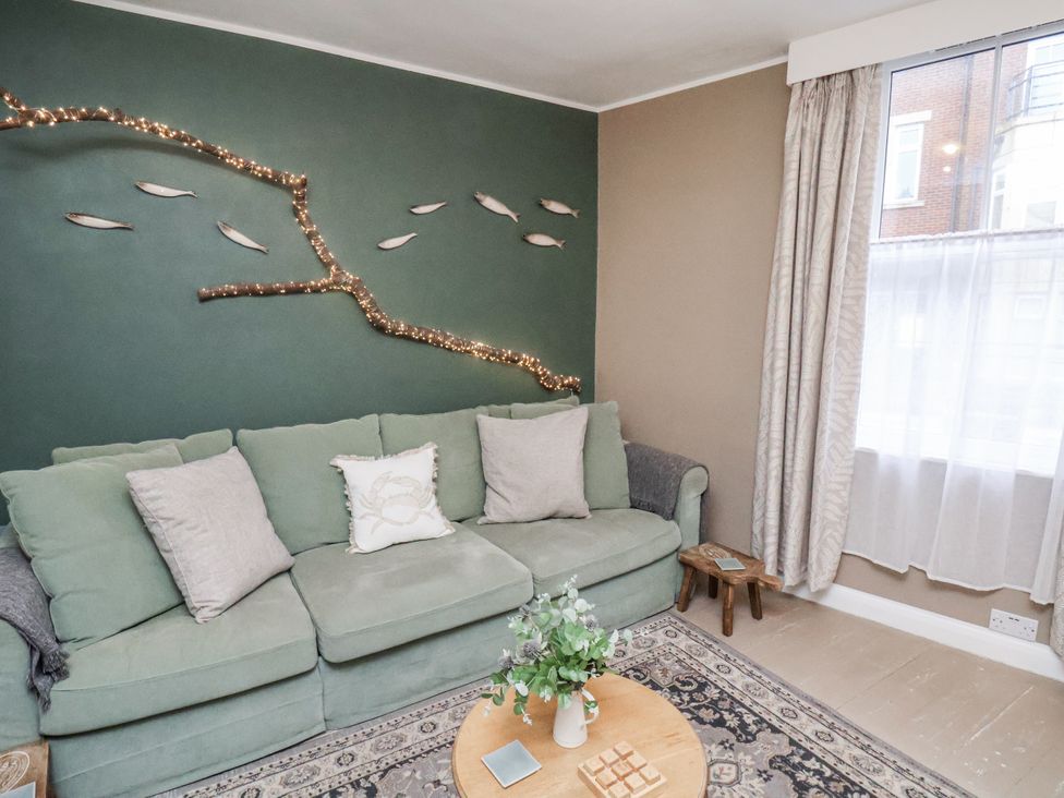 A living room with a sofa and decorative elements at Albion Cottage in Whitby