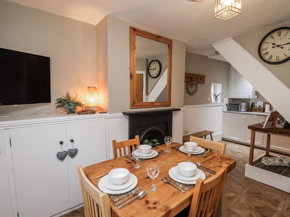 A dining area with a table set for a meal at Albion Cottage in Whitby