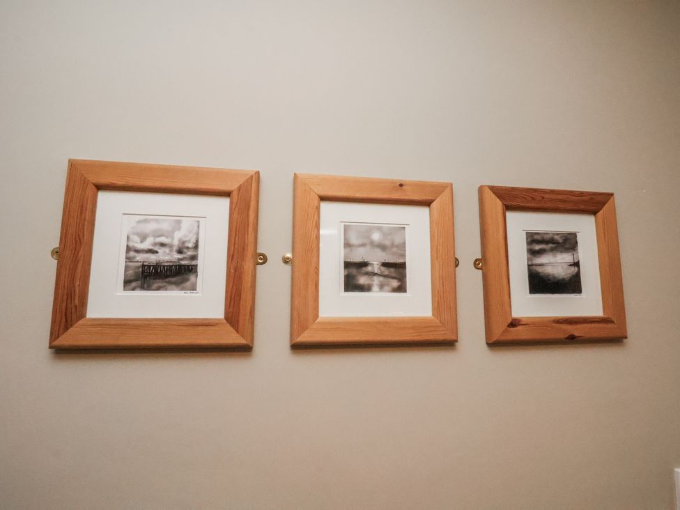 Three framed pictures on a wall at Albion Cottage in Whitby