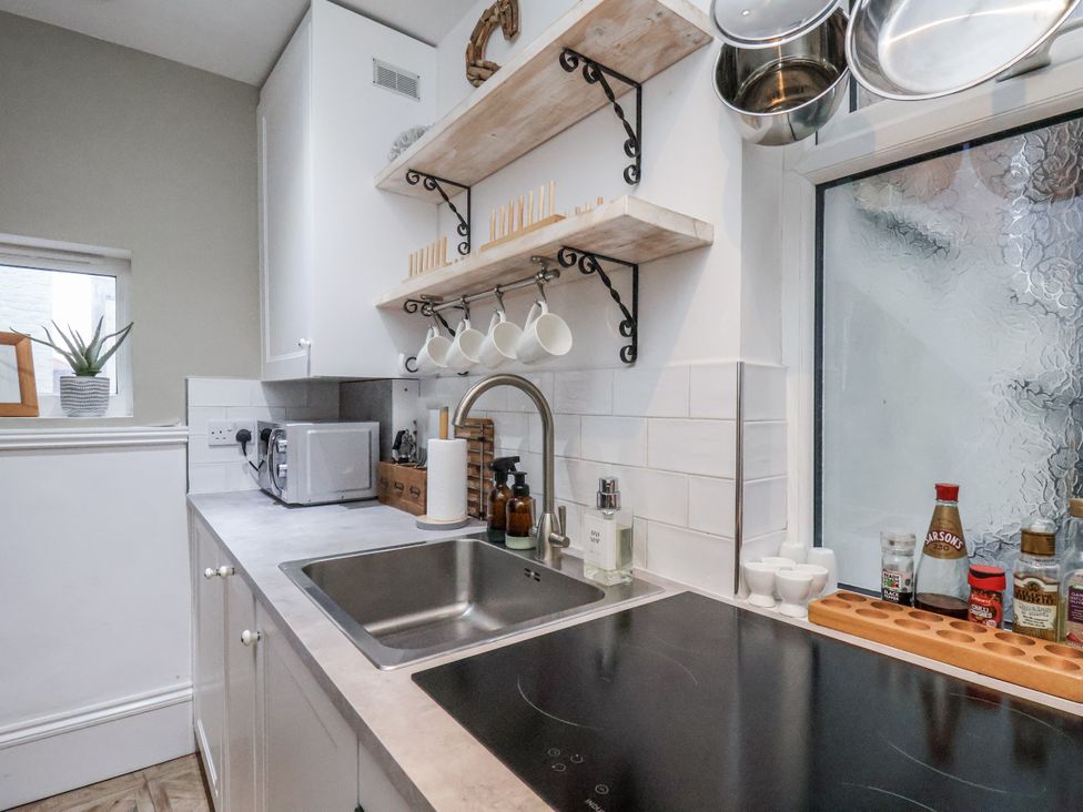 A kitchen with a sink and cooking hob at Albion Cottage in Whitby