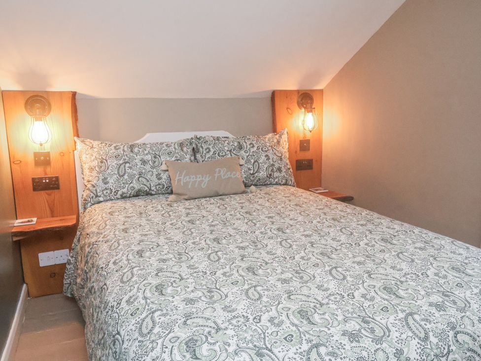 A bedroom with a bed and bedside lamps at Albion Cottage in Whitby