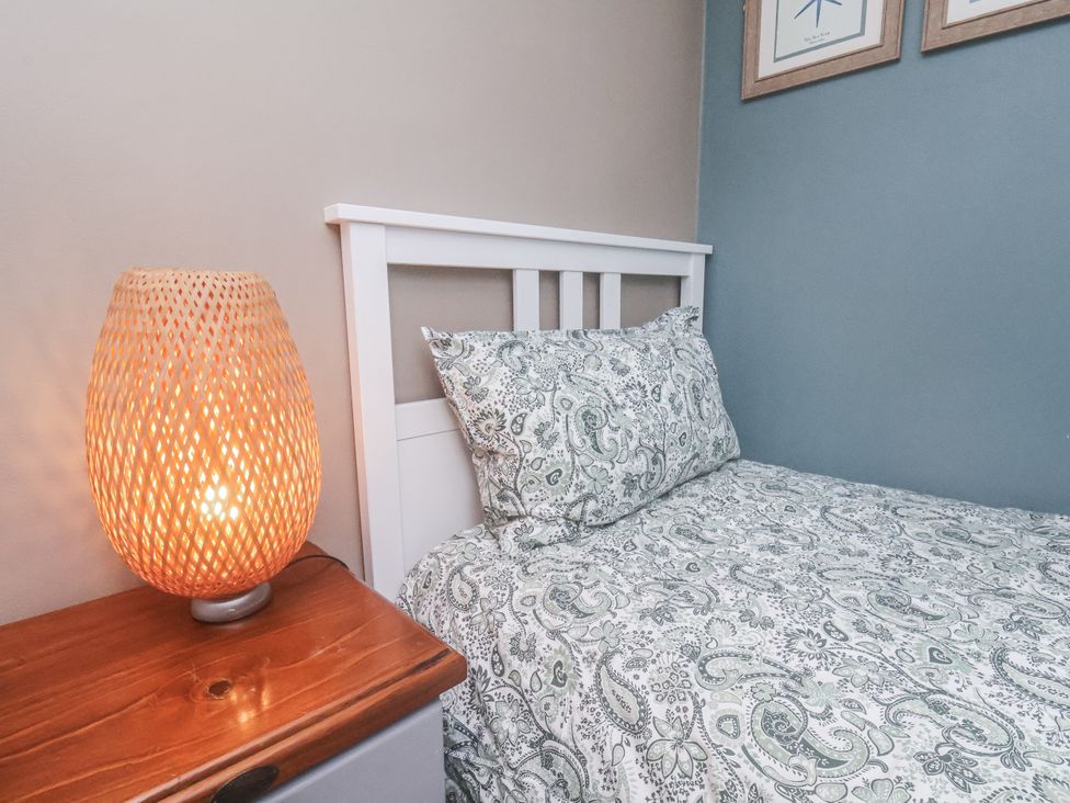 A bedroom with a bed and lamp at Albion Cottage in Whitby