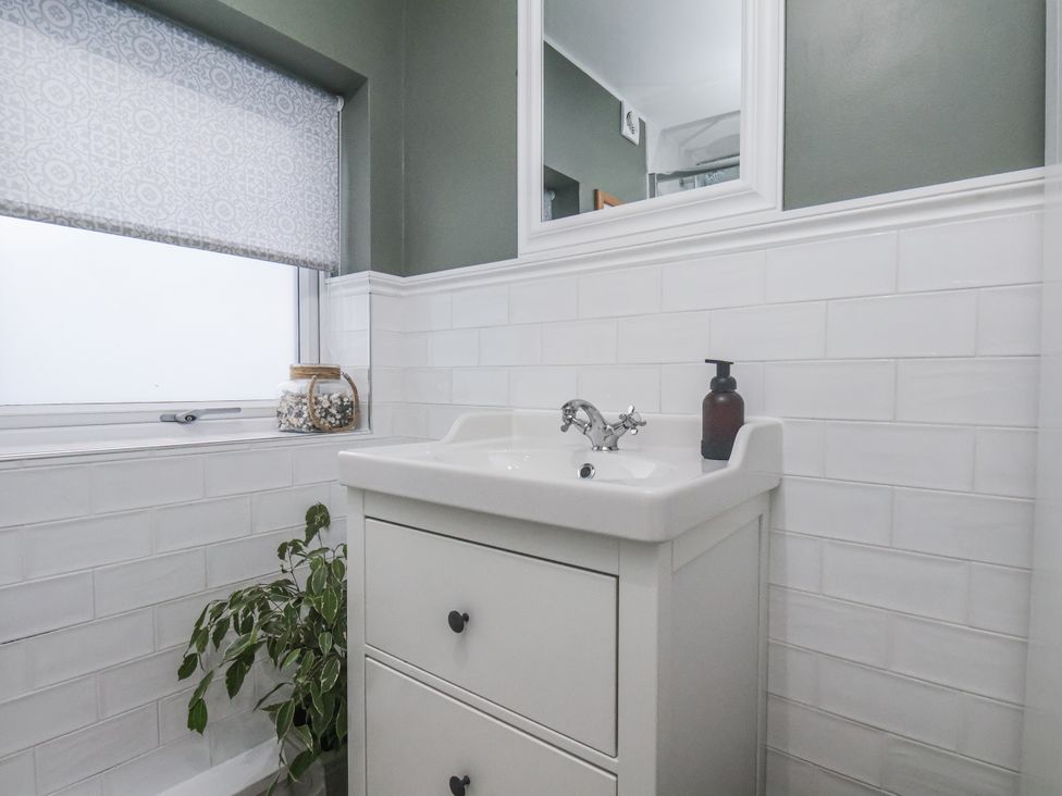 A bathroom with a sink and a window at Albion Cottage in Whitby