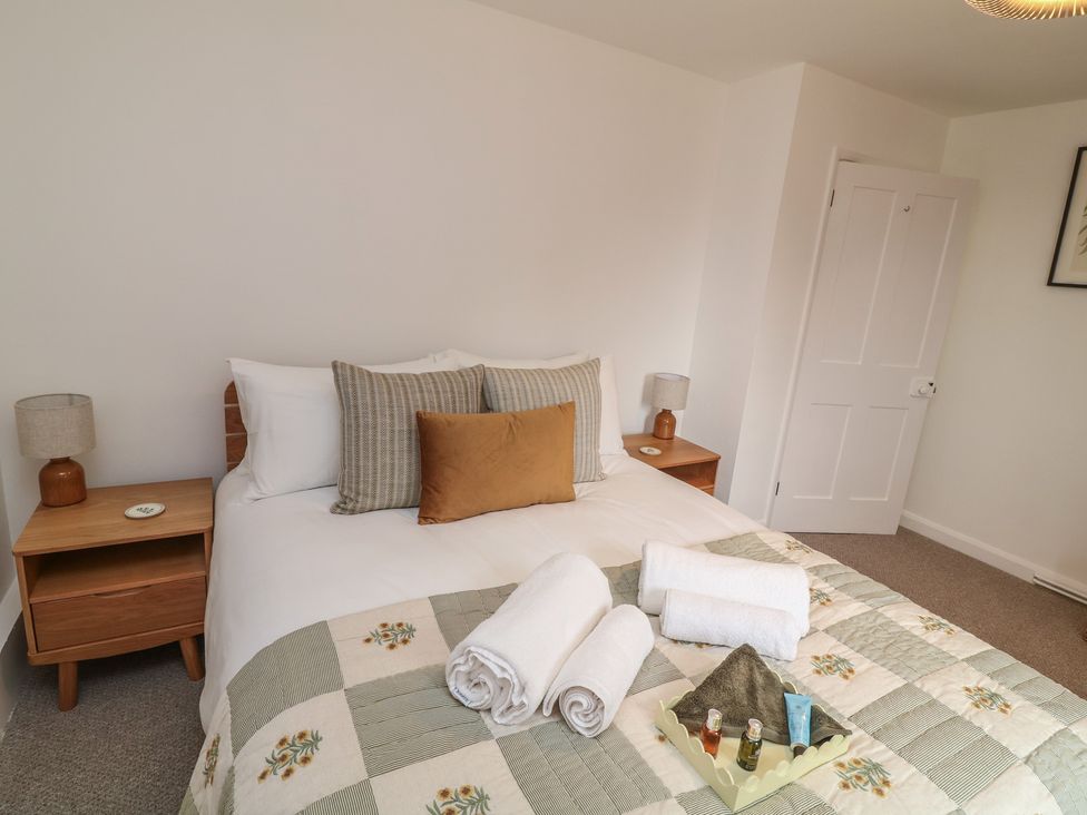 A bedroom with a bed and side tables at Casthorpe Lodge Cottage Barrowby