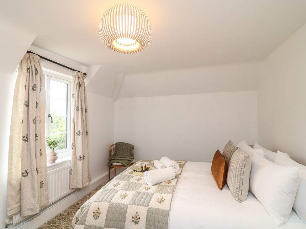 A bedroom with a bed and pillows at Casthorpe Lodge Cottage in Barrowby
