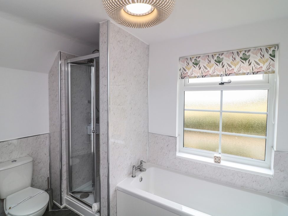 A bathroom with a toilet, shower, and bathtub at Casthorpe Lodge Cottage Barrowby