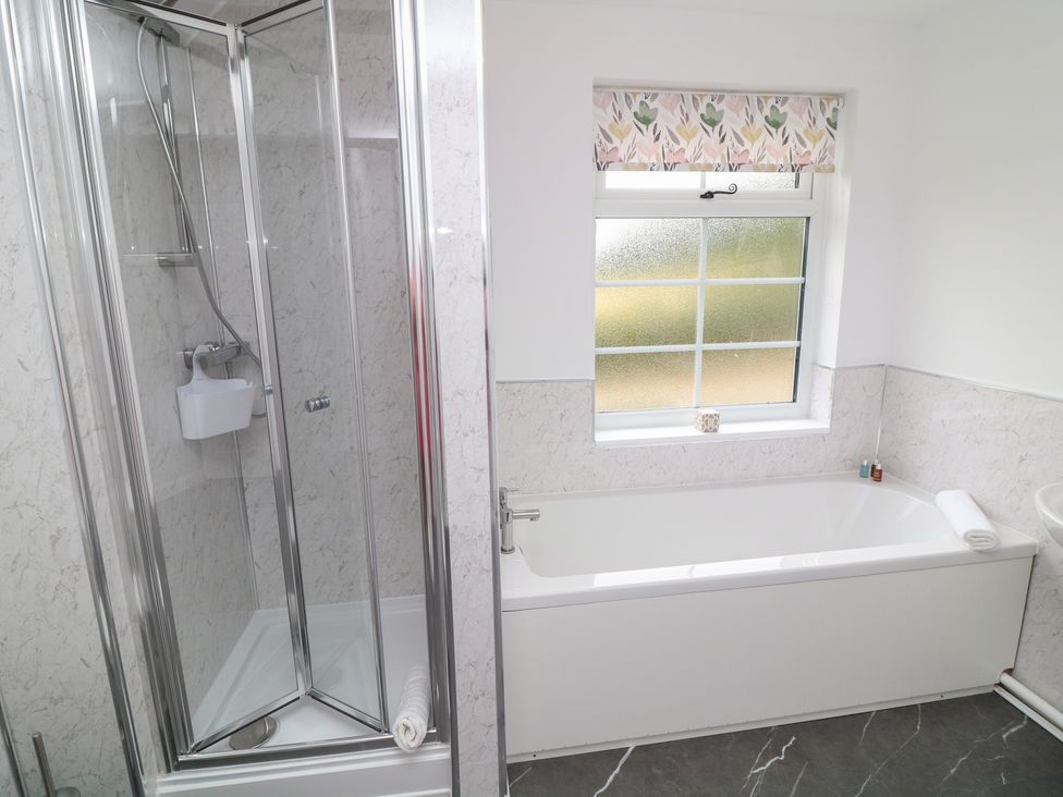 A bathroom with a shower and bathtub at Casthorpe Lodge Cottage Barrowby