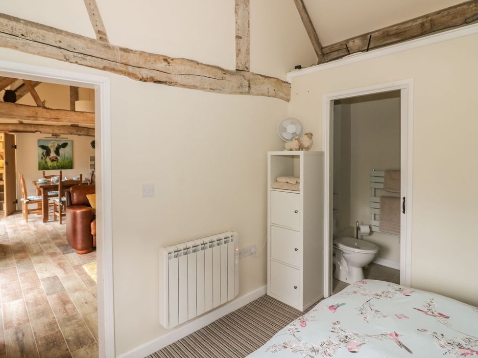 A bedroom with a bed and en-suite bathroom at Megs Cottage Stratford-upon-Avon