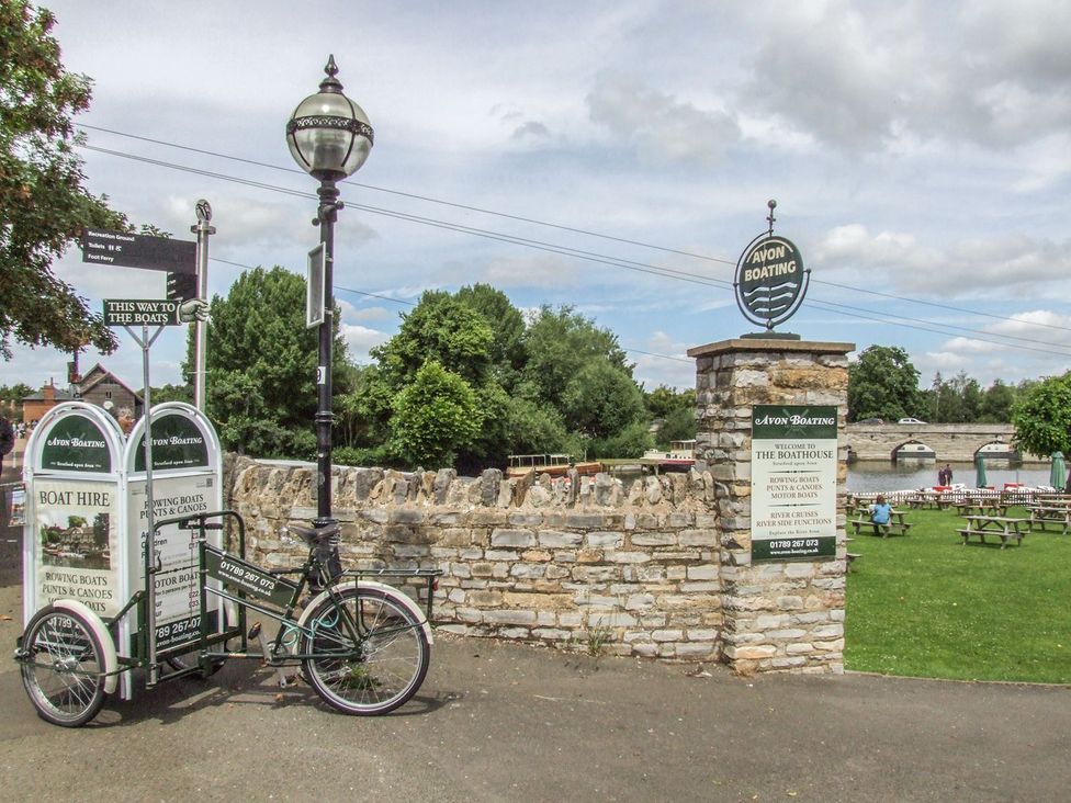 An outdoor view with a stone wall and signs at Avon Boating in Stratford-upon-Avon