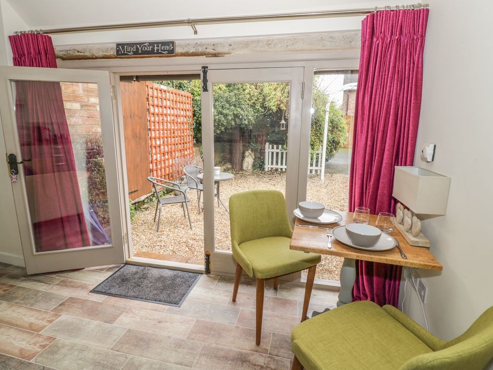 A dining area with a table and chairs at The Bolt Hole in Stratford-upon-Avon