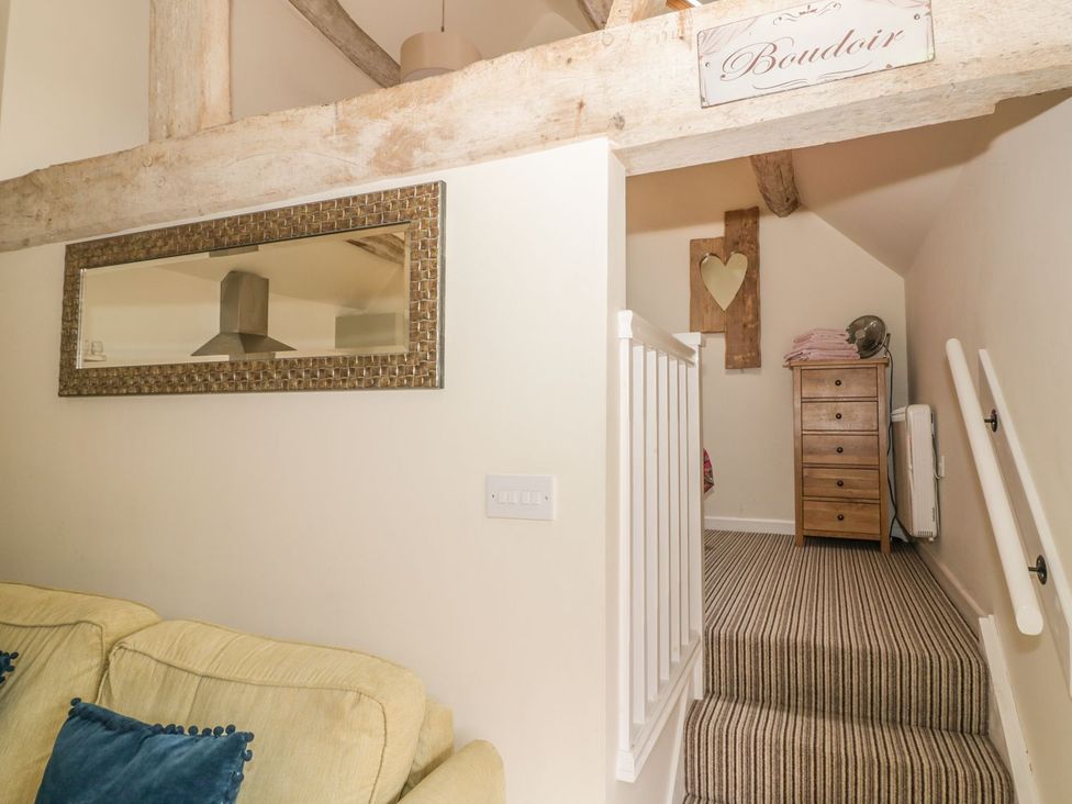 A hallway with stairs and a chest of drawers at The Bolt Hole Stratford-upon-Avon