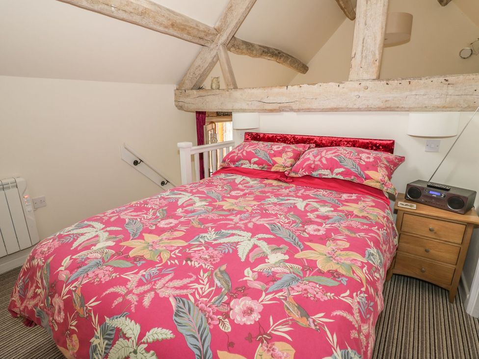 A bedroom with a bed and bedside table at The Bolt Hole in Stratford-upon-Avon