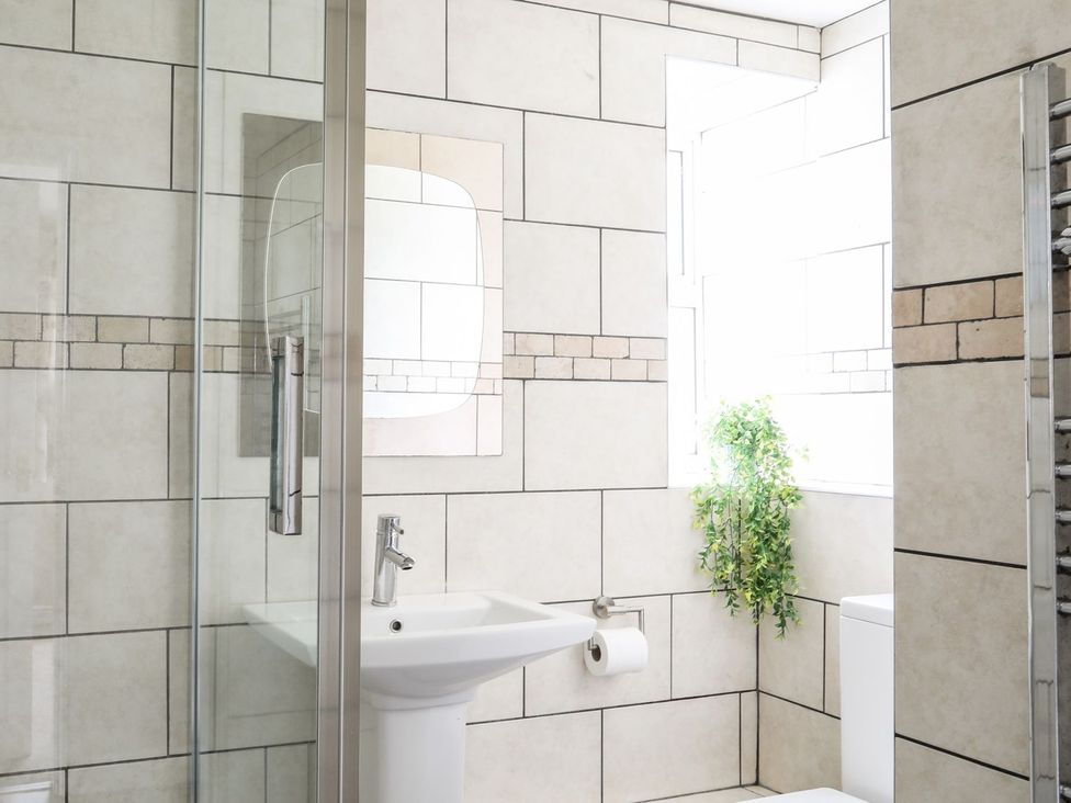 A bathroom with a shower and sink at Bodlasan Groes Cottage in Holyhead