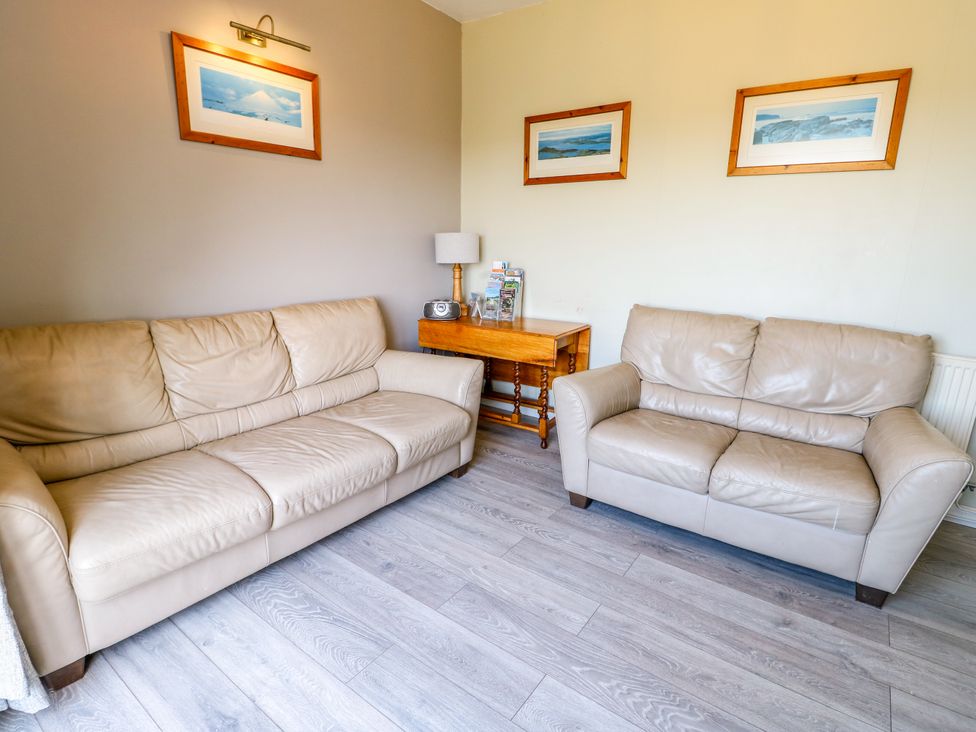 A living room with sofas and a coffee table at Bodlasan Groes House Llanfachraeth