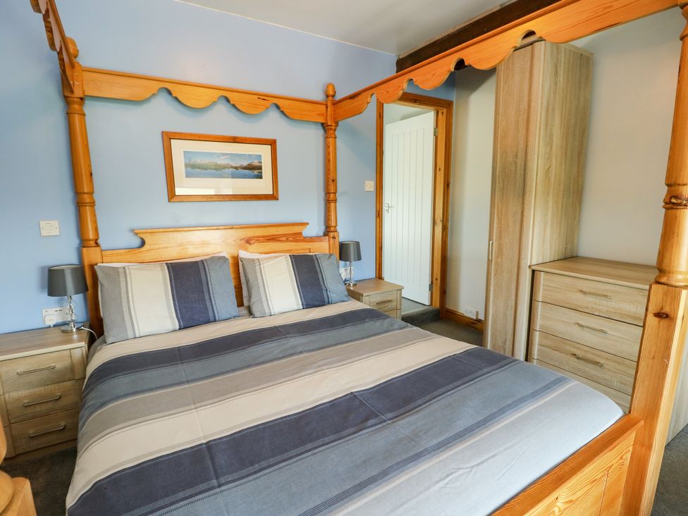 A bedroom with a four-poster bed and furniture at Bodlasan Groes House Llanfachraeth