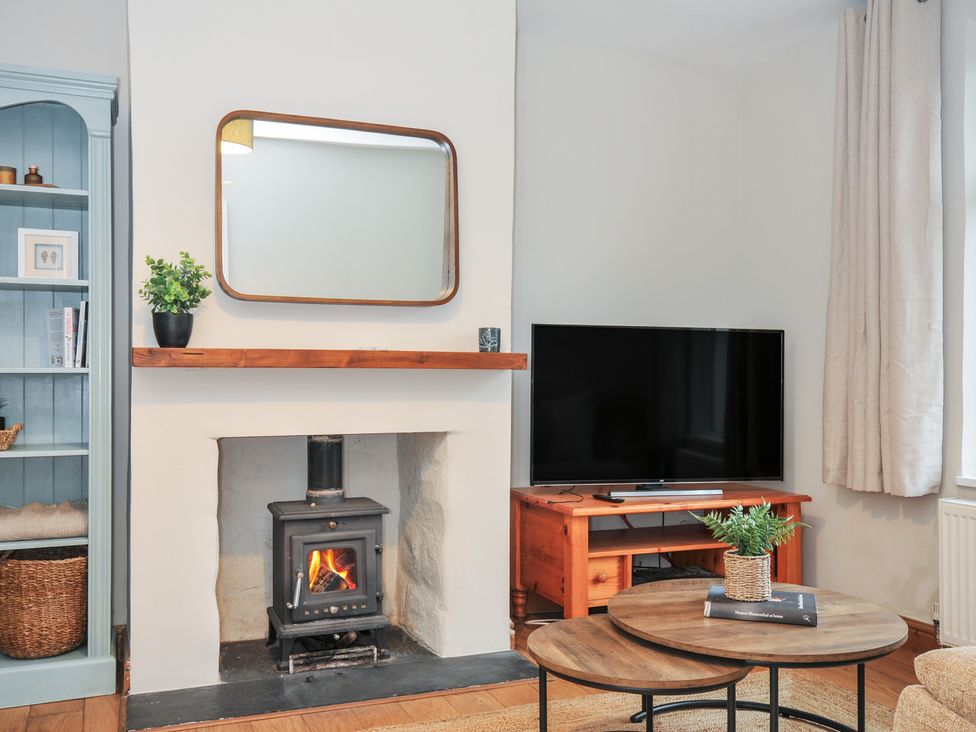 A living room with a fireplace and a television at 4 Polgrain Turning St. Wenn near St Columb Major