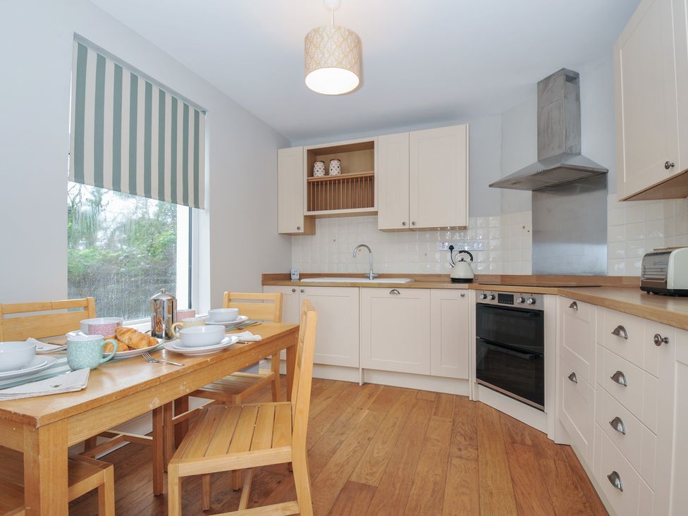 A kitchen with a table and chairs at 4 Polgrain Turning St. Wenn near St Columb Major