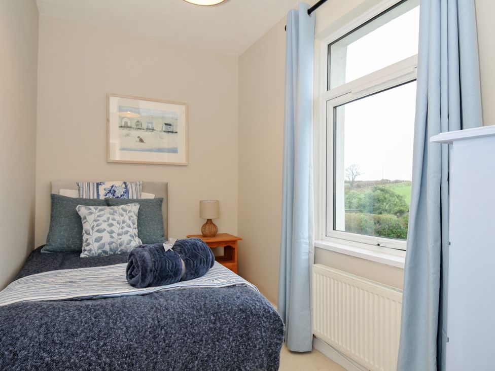 A bedroom with a single bed and a window at 4 Polgrain Turning St. Wenn near St Columb Major