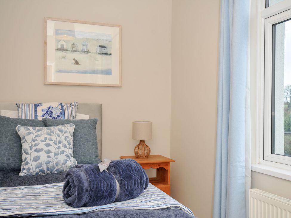 A bedroom with a bed and pillows at 4 Polgrain Turning St. Wenn near St Columb Major