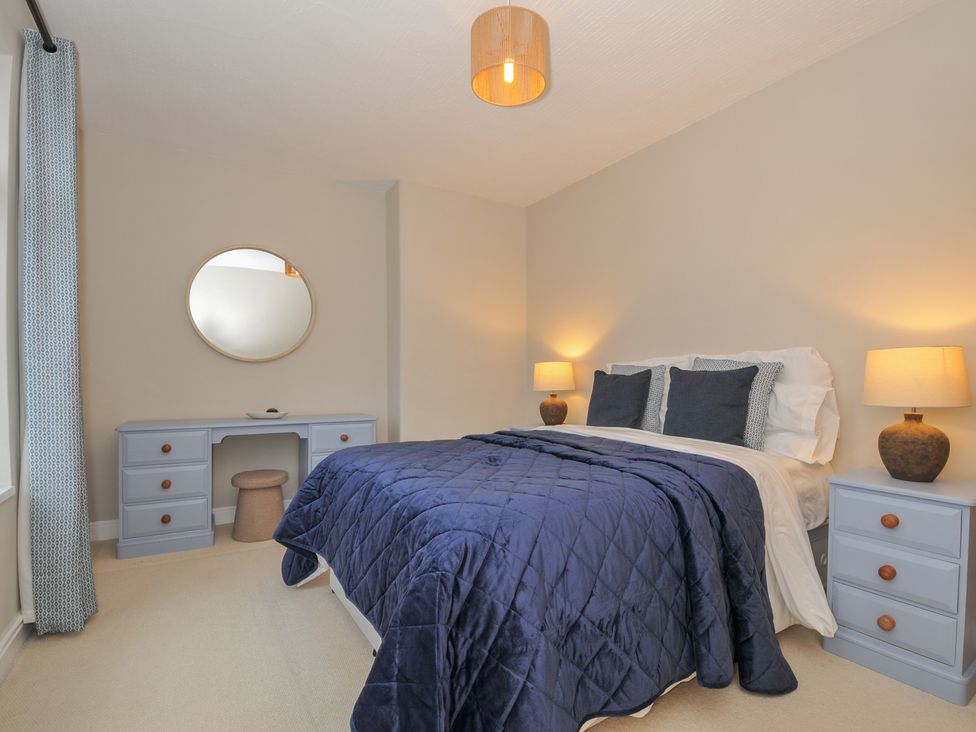 A bedroom with a bed and dressing table at 4 Polgrain Turning St. Wenn near St Columb Major