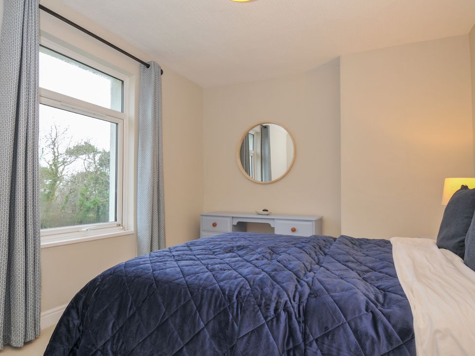 A bedroom with a window and a desk at 4 Polgrain Turning St. Wenn near St Columb Major